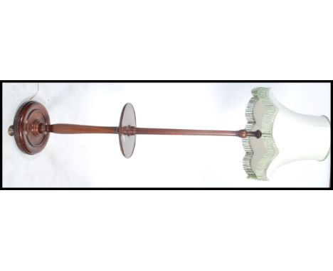 A 19th century Victorian mahogany standard lamp having a circular base with block and turned stem with central tray and light