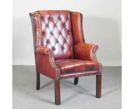A Georgian style leather upholstered button back wing armchair, mid 20th century, on square legsOverall condition is complete