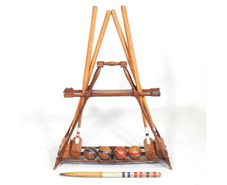 A mid 20th century F.H. Ayers, London wooden The Usborne patent Croquet Carrier Stand, with four mallets, balls and marker, 1