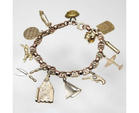 An early 20th century charm bracelet, suspended with a collection of twelve various novelty charms, to include a spitfire, sa