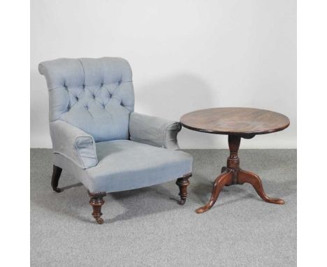 A Victorian blue upholstered button back armchair, on turned legs, together with an occasional table, on a tripod base (2)