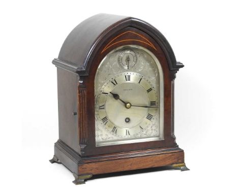 An early 20th century bracket clock, by Maple &amp; Co., with an inlaid lancet shaped case and signed silvered dial, with a s