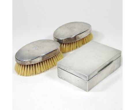 A silver table cigarette case, with engine turned decoration, Birmingham 1940, 14cm wide, together with a pair of silver back