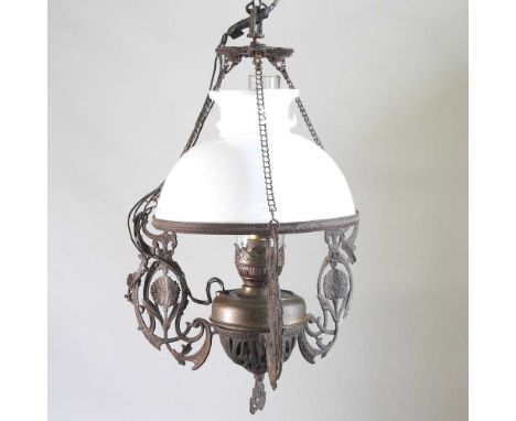 An early 20th century ceiling light, with an opaque white glass shade and scrolled supports, 47cm high