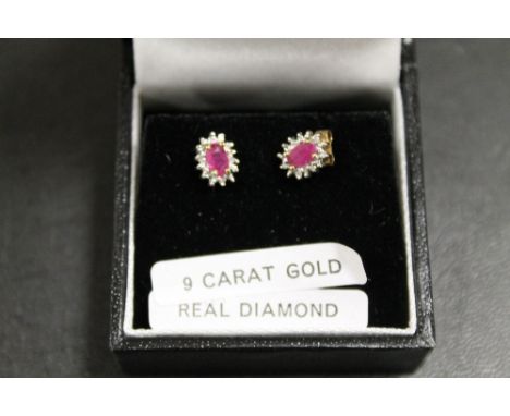 A PAIR OF A RUBY AND DIAMOND SET EARRINGS
