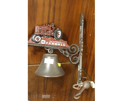 A MODERN REPRODUCTION CAST METAL WALL MOUNTED TRACTOR BELL