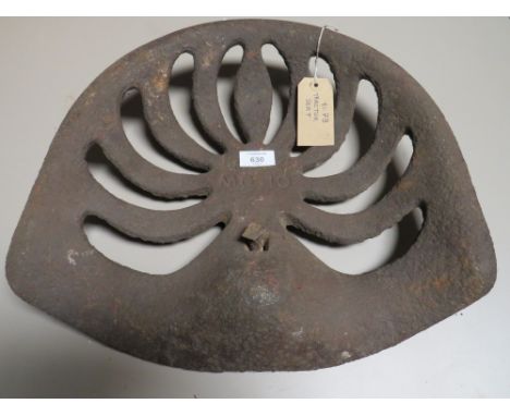 A VINTAGE CAST METAL TRACTOR SEAT