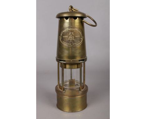 A brass miners safety lamp. Made by The Wolf Safety Lamp Co, Wm Maurice Ltd Sheffield. H: 27.5cm.  
