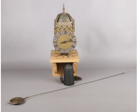 A Thomas Moore, Ipswich, brass lantern clock with pendulum and weight, and later bracket.  