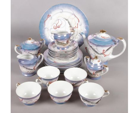 A Japanese part teaset with lithophane panel depicting a Geisha girl.  