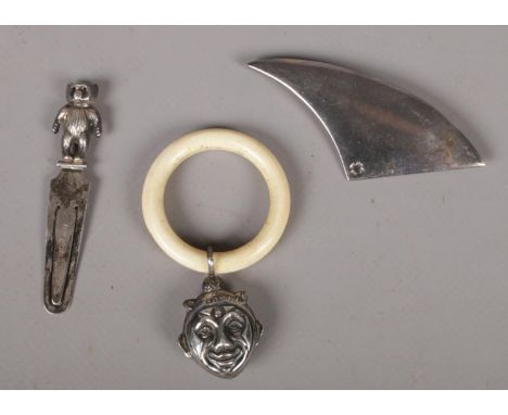 Three items of silver to include paperclip book mark with bear finial, Baby's teething ring &amp; rattle, brooch. (various ha