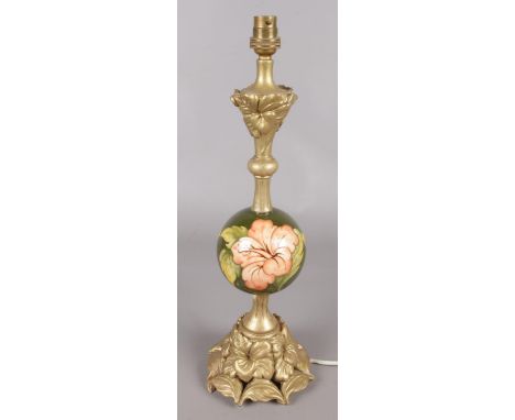 A Moorcroft table lamp. With gold painted stand and column, Hibiscus pattern.  Chips to composite stand.