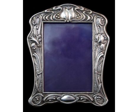 An Edwardian silver mounted photo frame by William J Holmes, Birmingham 1902, of shaped rectangular form with easel support a