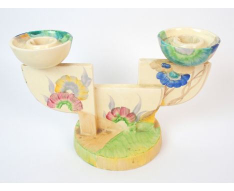 A Clarice Cliff "Rhodanthe" painted ceramic double candlestick circa 1930, centre stepped demi-lune standard mounted with bis