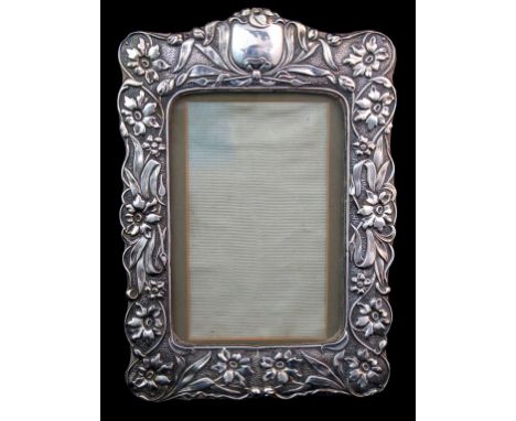 An Edwardian silver mounted photo frame maker's name S & Co., Birmingham 1902 of rectangular form with easel support and flor