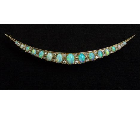 A large Victorian opal and diamond crescent moon brooch the graduated oval opal cabouchons with good green/ blue/purple colou