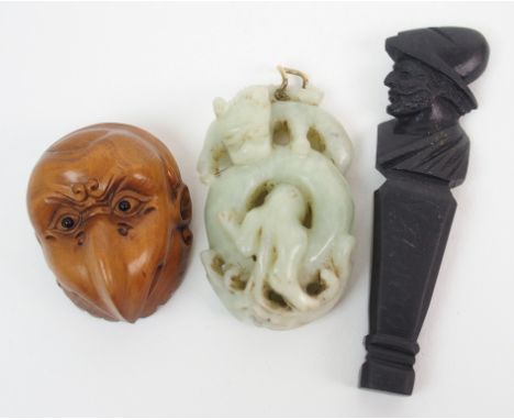 A Chinese jade carving of an entwined dragon 5.5cm wide, carved wood netsuke double mask, 4cm wide and a lava carved seal ins