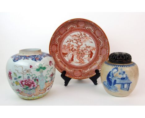 A Chinese famille rose jar painted with vases of flowers, 17cm high, blue and white crackled jar painted with a lady at a tab