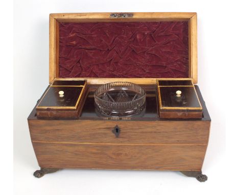 An English Regency mahogany tea caddy circa 1815, of sarcophagus-form with bands of stringing, hinged lid opening to two fitt