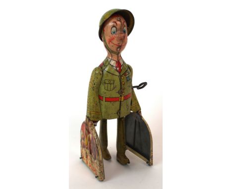 A Clockwork tinplate figure G I Joe and the K-9 pups, 23cm high