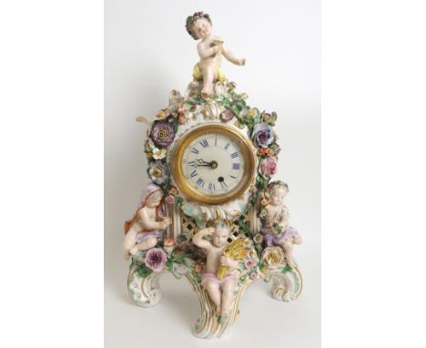 A Meissen-style figural porcelain mantle clock 20th Century, shaped clock with seated putto to crest and three seated above f