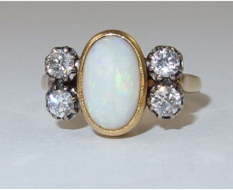 An 18ct white opal and diamond ring an oval white opal of approx 10.6mm x 7mm flanked by two brilliant cut diamonds to each s