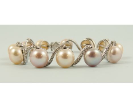 A 14ct pearl and diamond bracelet with button shaped cultured pearls in pastel shades with dividing swirl links set with diam