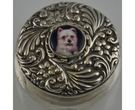 A silver and enamel set embossed container 