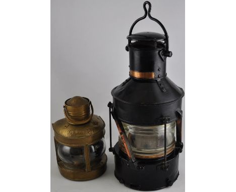 A 1945 anchor light, painted black, H. 45cm, together with a brass masthead light (2)