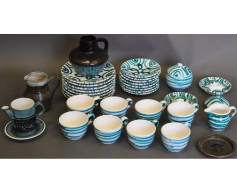 An Austrian glazed pottery breakfast set, decorated with green loops on a white ground, comprising eight cups and saucers, ei