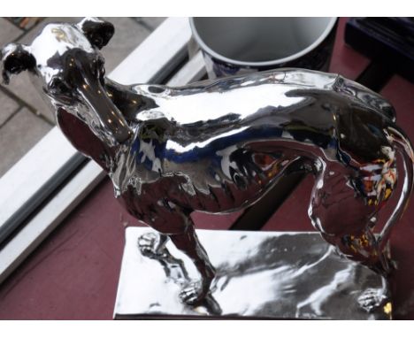 A silvered composition model of a standing whippet, h:66cm