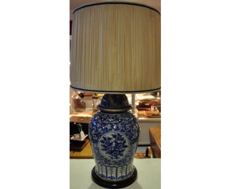 A large Chinese blue and white porcelain baluster jar and cover decorated with panels of flowers, converted to a table lamp w