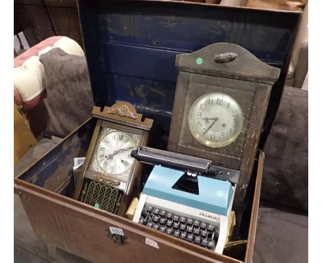 Vintage tin travel trunk containing two wall clocks and a Lilliput typewriter, 73 x 47 x 40 cm H. Not available for in-house 