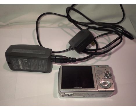 Olympus Hyper crystal LCD digital camera and a Olympus LI-ion battery charger. P&amp;P Group 2 (£18+VAT for the first lot and