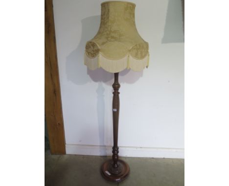 A 20th Century walnut standard lamp with shade 