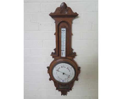 A Victorain carved oak Aneroid barometer with thermometer and presentation plaque - 88cm H 