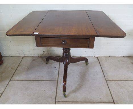 An early 19th Century mahogany drop leaf table with single frieze drawer on a turned column and tripod legs with castors 