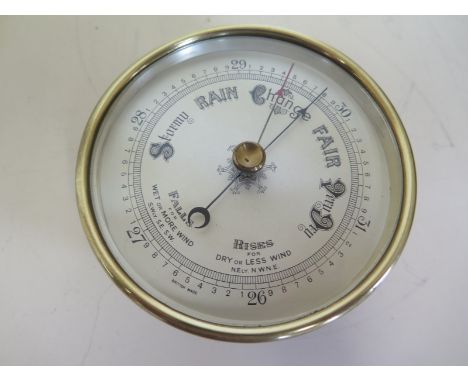 A brass barometer 5 dial - 26 to 31 - No 6267/39 - Military mark on back with crowsfoot 11 - 13cm diameter 
