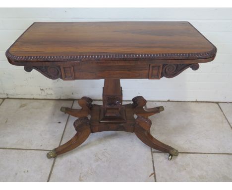 A good 19th Century rosewood foldover card table with a scroll frieze on a quartefoil base  - in good clean restored conditio