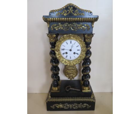 An ebonised French Portico clock with gilt decoration - 8 day movement, strikes on bell - 50cm tall 