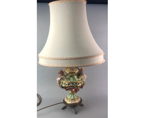 CONTINENTAL CERAMIC LAMP, of urn form, raised on a brass stand, with shade, 72cm high