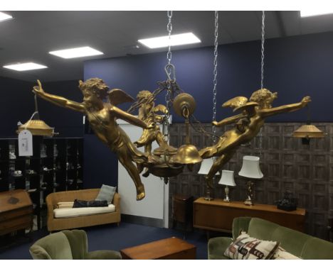 GILT RESIN FIGURAL CHANDELIER, modelled with cherubs, three light fittings, 84cm wide, along with three further wall lights