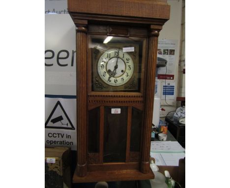 OAK CASED DIAL CLOCK WITH ENAMEL AND BRASS DIAL. REEDED COLUMNS AND GLASS PANELS 