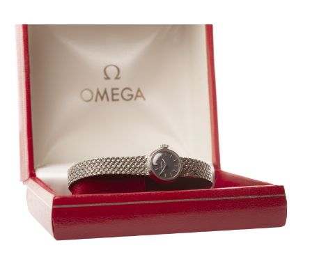 LADY'S OMEGA NINE CARAT WHITE GOLD MANUAL WIND WRIST WATCH, the round dark blue dial with applied baton hour markers, pencil 
