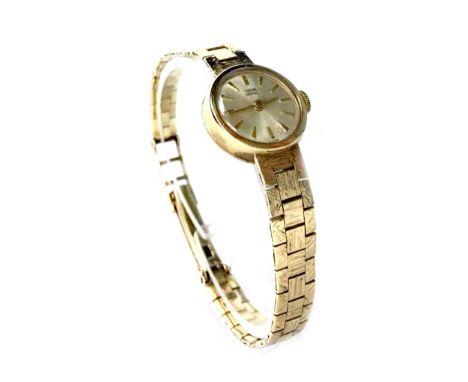 LADY'S TUDOR NINE CARAT GOLD MANUAL WIND WRIST WATCH, early 1970s, the round silver coloured dial with applied wedge hour mar