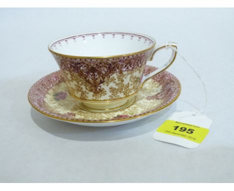 A Royal Worcester cup and saucer painted in coloured enamels with flowers by Milly Hunt. Signed