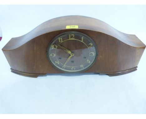 An Art Deco walnut mantle clock, the three train movement striking and chiming on five tubular gongs. 23' wide