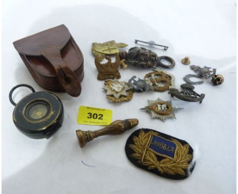 A WW1 military marching compass in leather case together with military badges etc.