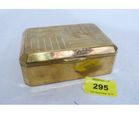 A brass engine turned cigarette box, the underside stamped Marcovitch Black and White Cigarettes. 4 1/2' wide