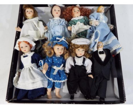 Dressed Miniature Dolls - Eight dressed miniature hand painted ceramic dressed dolls / doll's house family to include a maid,